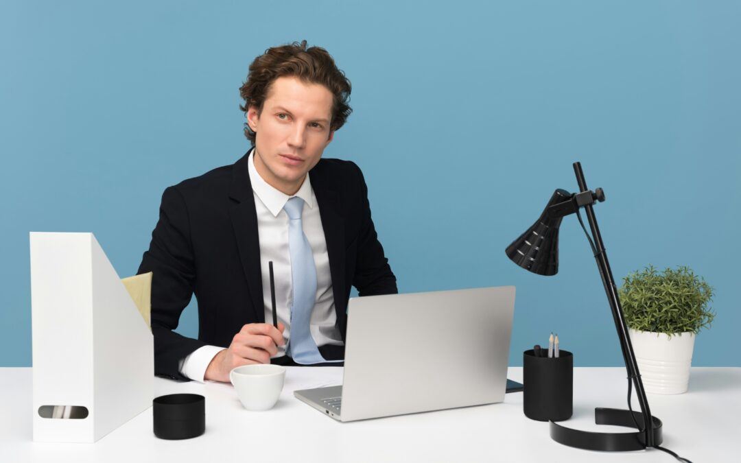 Man at desk, blue background,